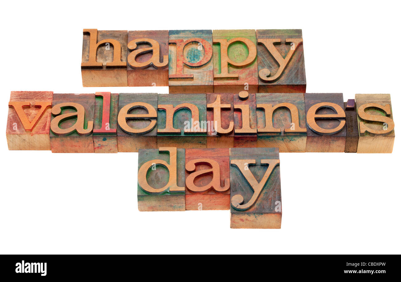 Happy Valentine day tient dans la typographie en bois vintage blocks, tachés par les encres de couleur, isolated on white Banque D'Images