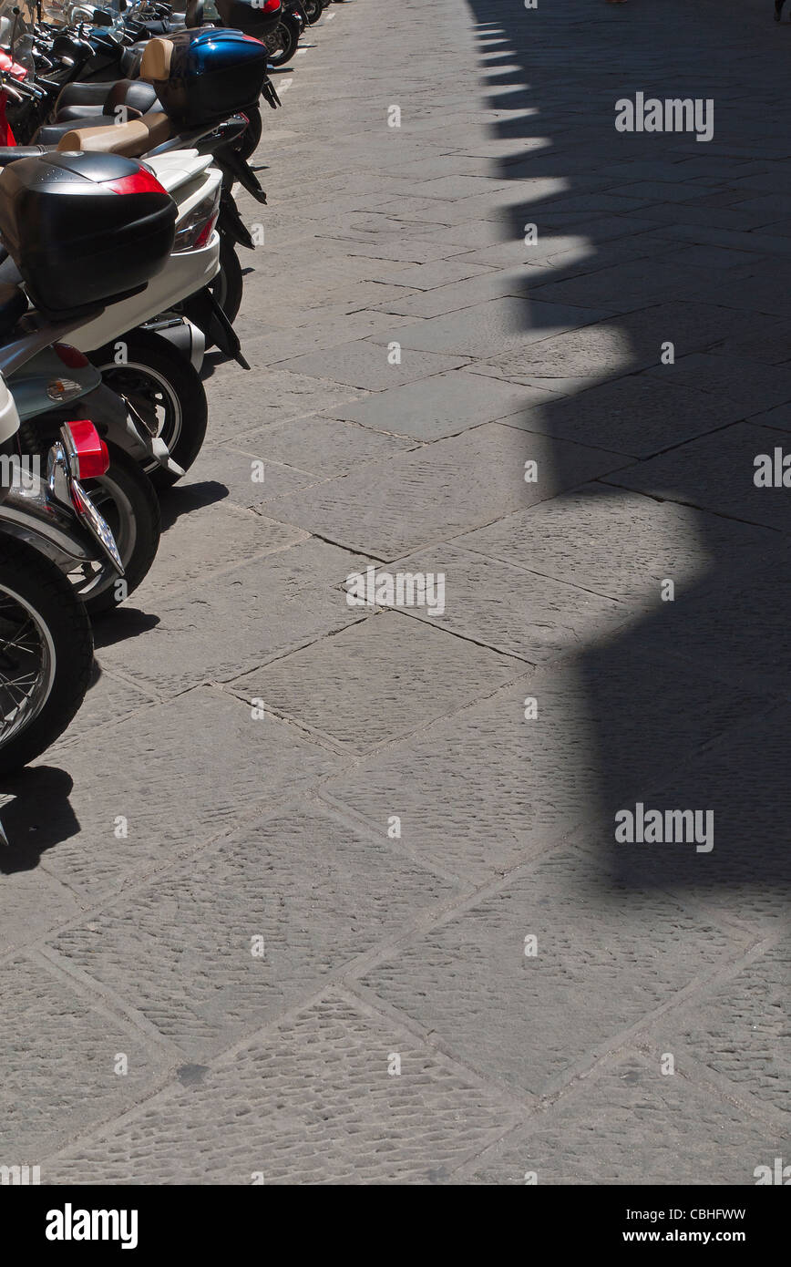 Point de vue un point créé par une combinaison de bordée d'motorscooters les motos et d'un côté et l'ombre sur d'autres. Banque D'Images