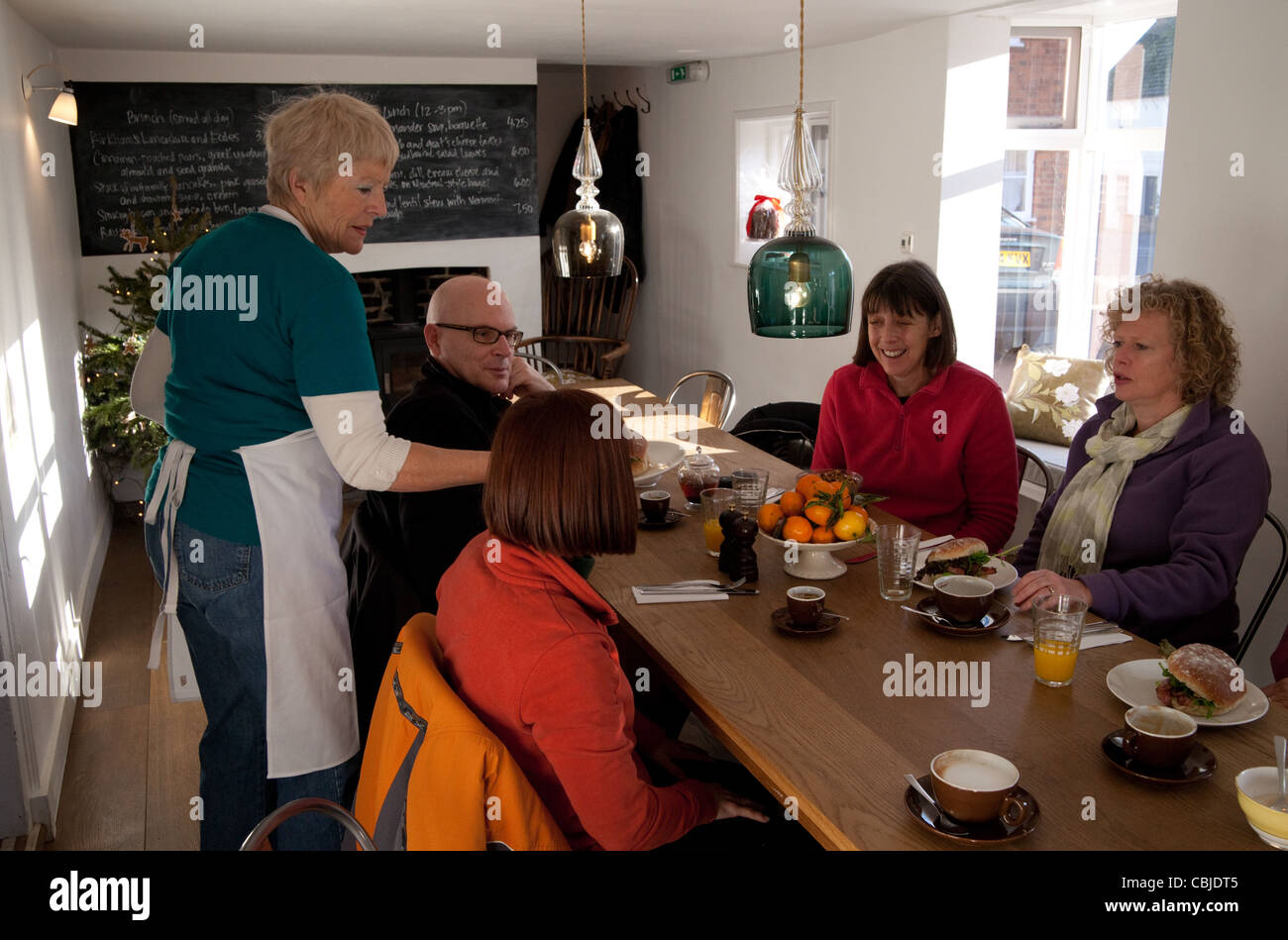 Petit-déjeuner personnes desservies par la serveuse, Rue de la pompe, la boulangerie du village Orford UK Suffolk Banque D'Images
