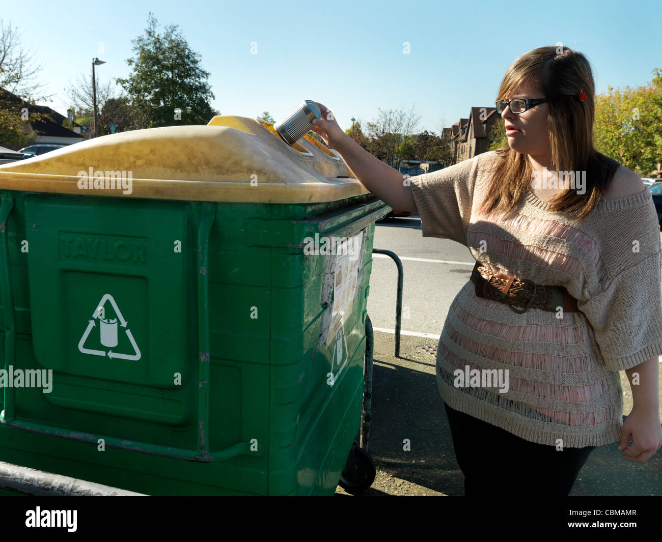 Woman Putting peut en Angleterre Banque de recyclage Banque D'Images