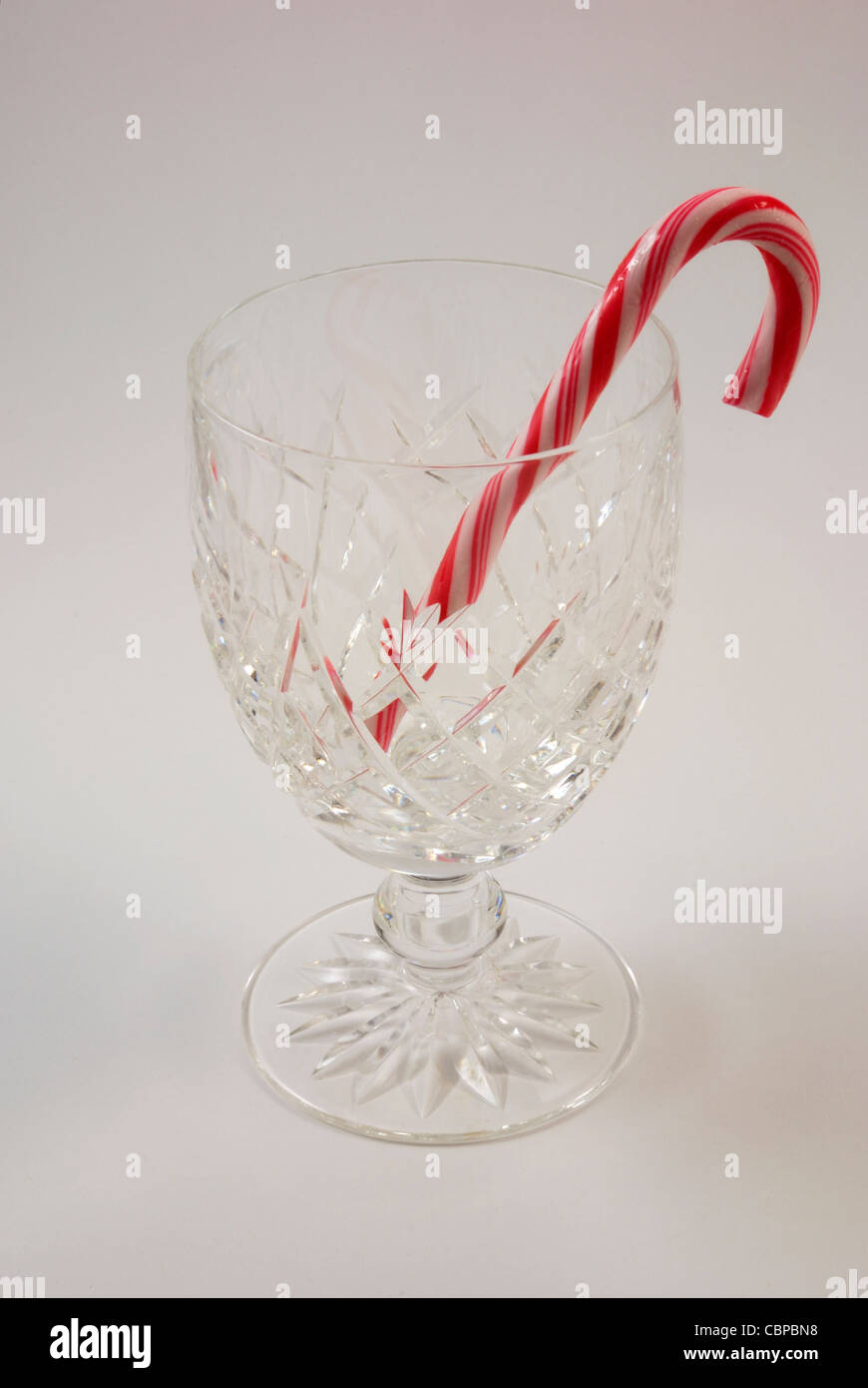 Une canne de Noël rouge et blanc dans un verre de cristal Waterrford Banque D'Images