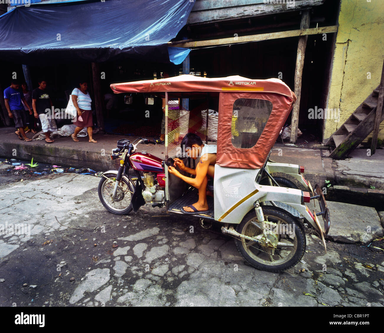 La fixation des composants électriques sur un rickshaw motortaxi motortrike dans Belen Iquitos Perou Banque D'Images