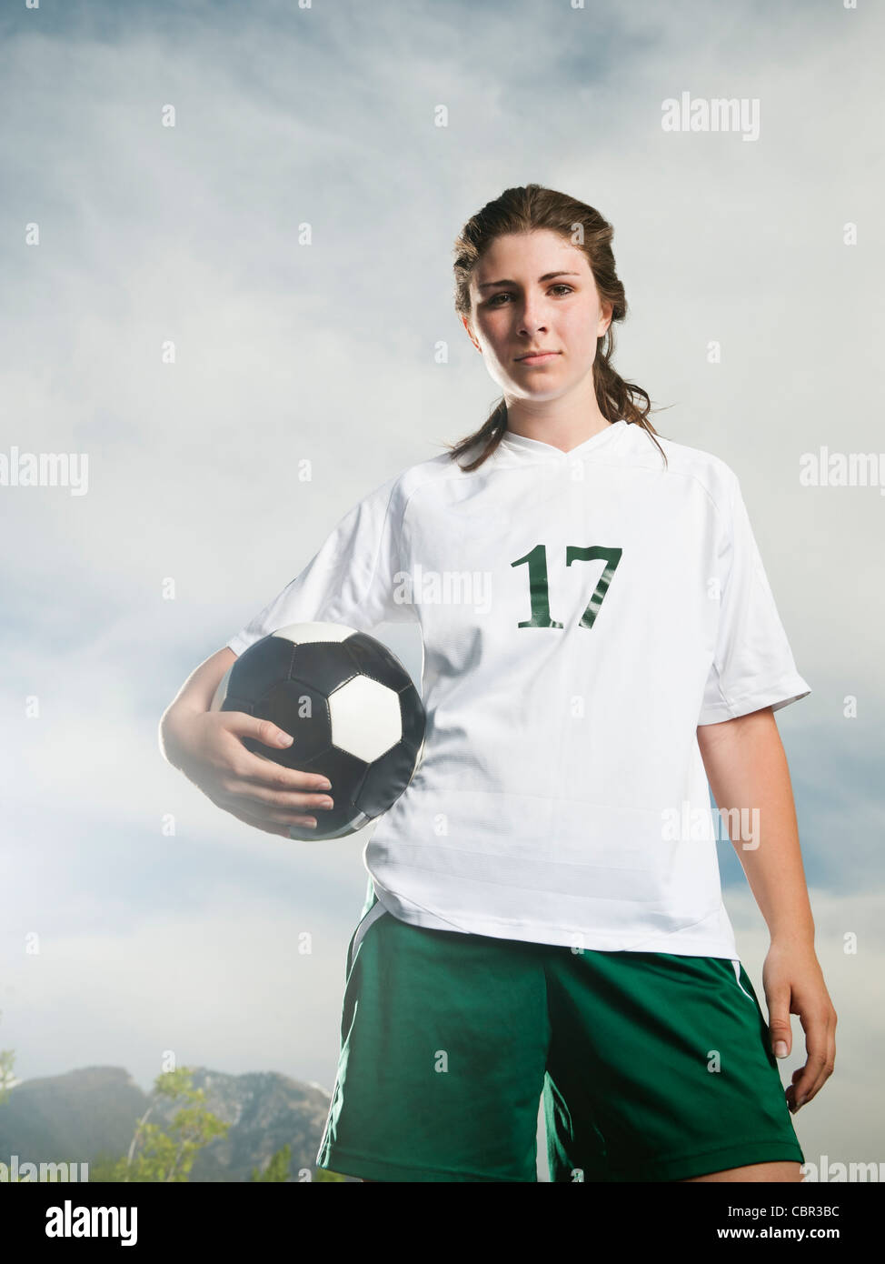 Young soccer player holding ball Banque D'Images