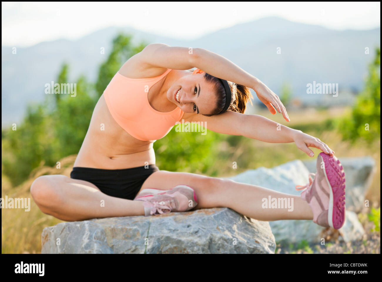 Caucasian woman stretching entraînement avant Banque D'Images