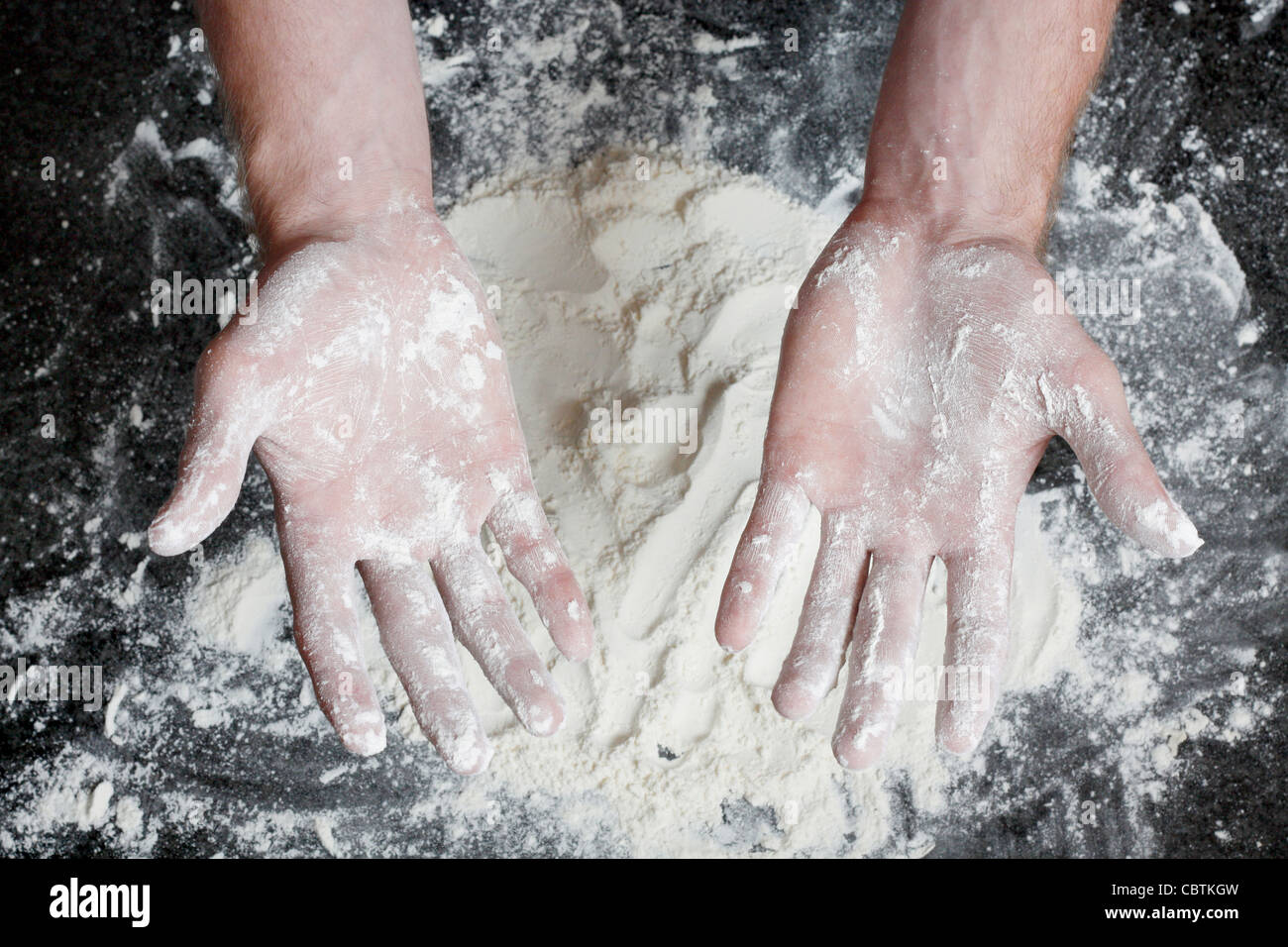 Salir les mains avec de la farine blanche après la préparation Banque D'Images