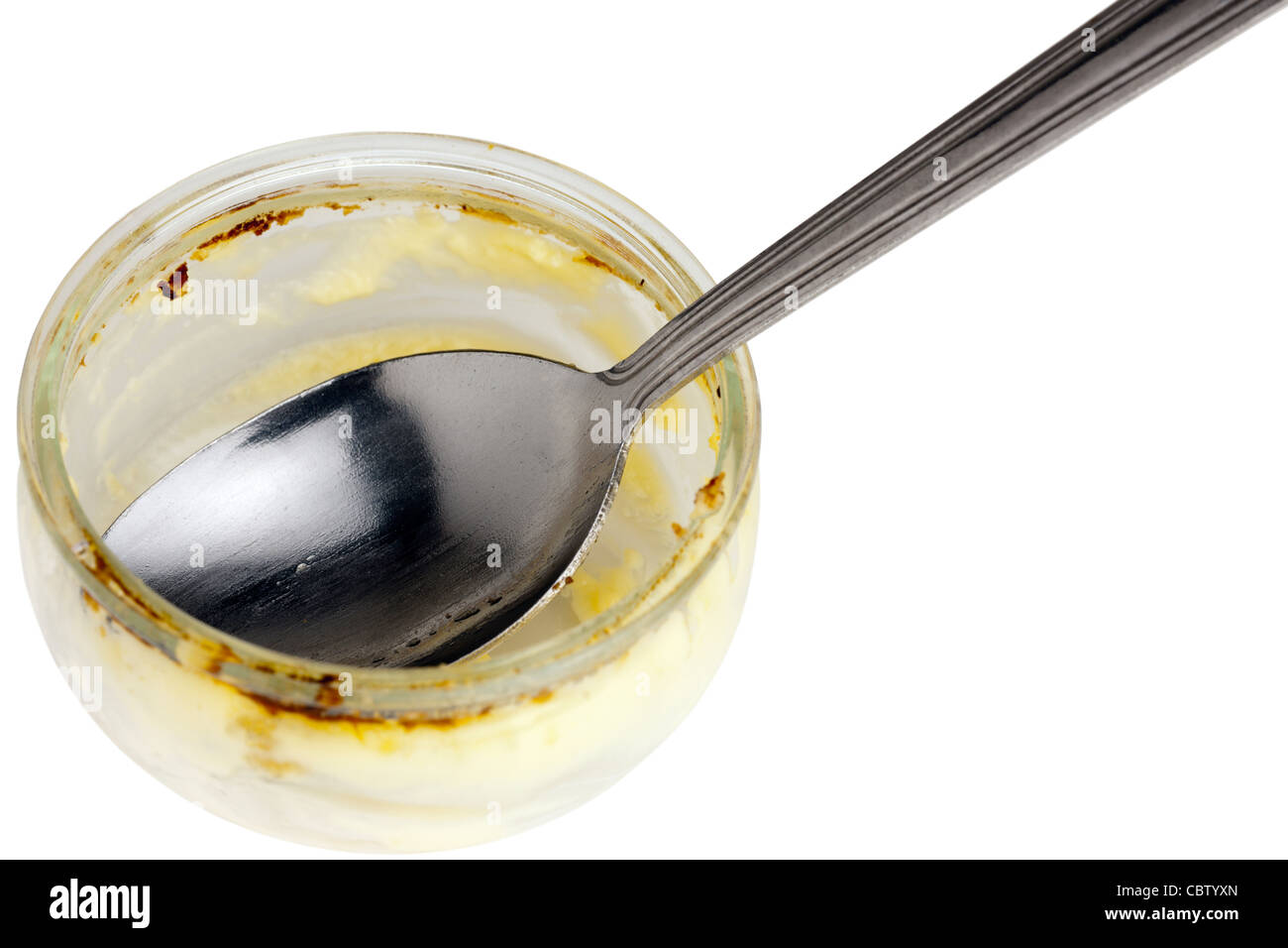 Petit désert vide brûlée contenant de verre et cuillère Banque D'Images