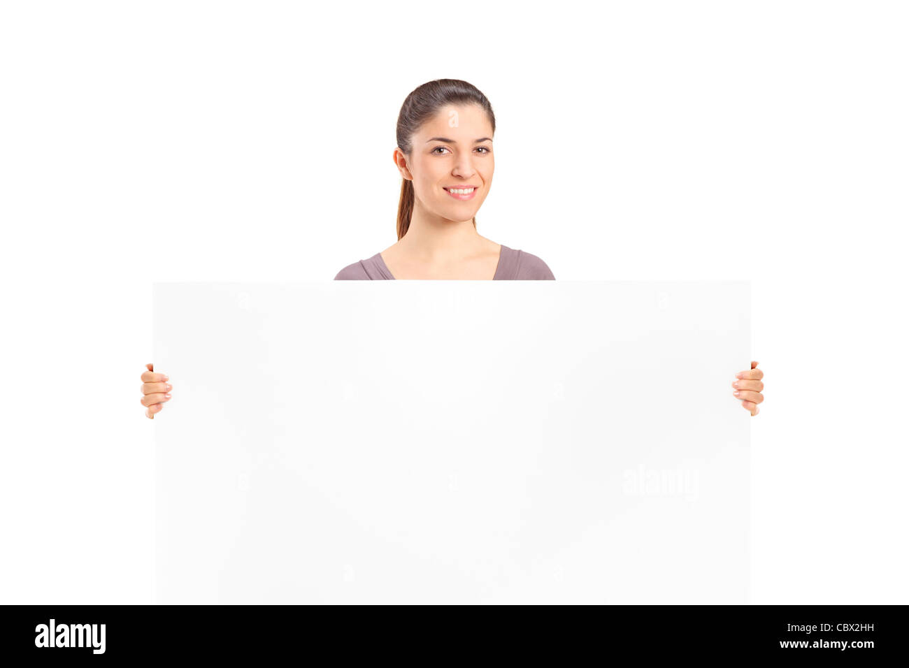 Une happy woman holding a blank billboard Banque D'Images