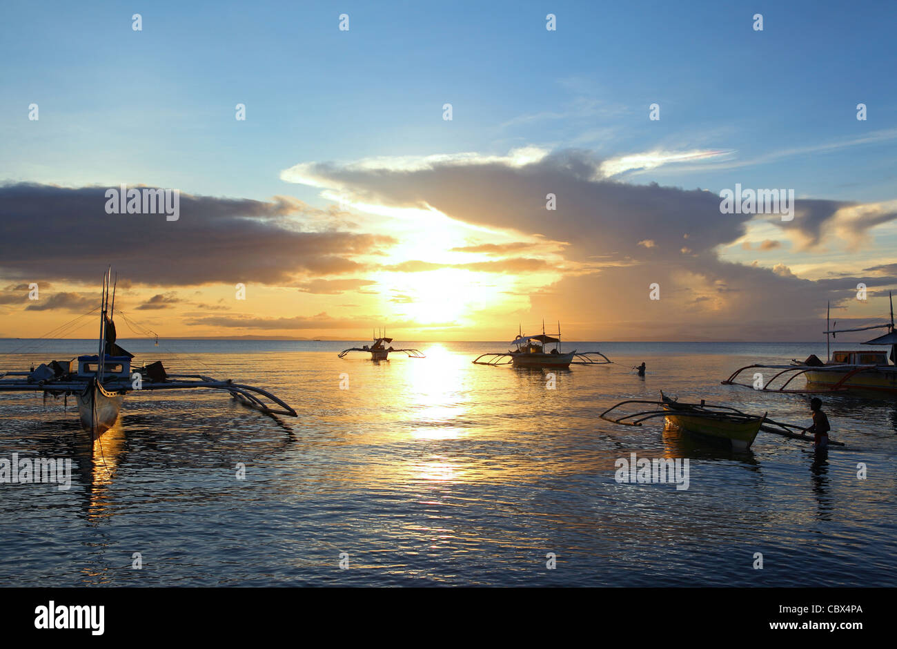 La pêche aux tangons bateaux ancrés au large Donsol dans le plage au coucher du soleil. De Luçon, au large Donsol dans la province d'Albay, Bicol, Philippines, Asie du Sud-Est, Asie Banque D'Images