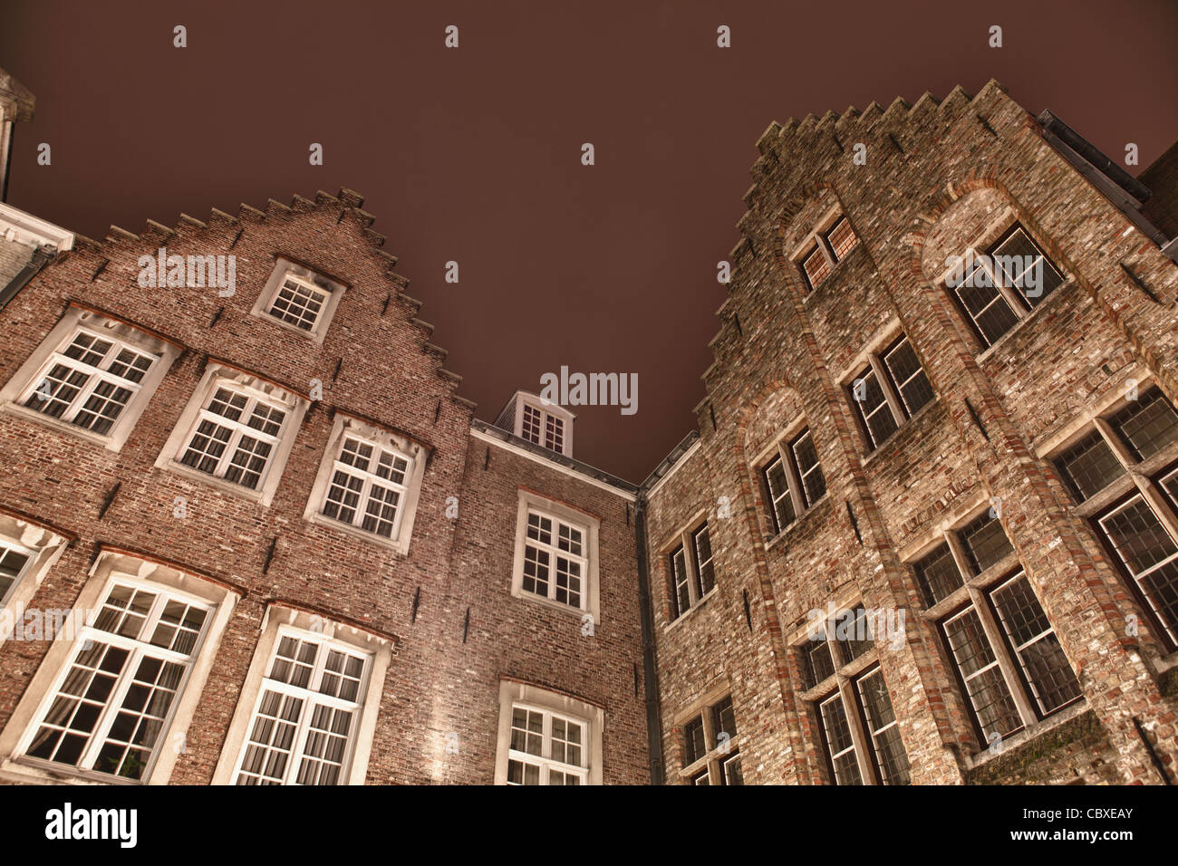 Photo de deux édifices de l'architecture flamande traditionnelle situé à Brugge (Bruges), Belgique. Photo prise dans la nuit. Banque D'Images