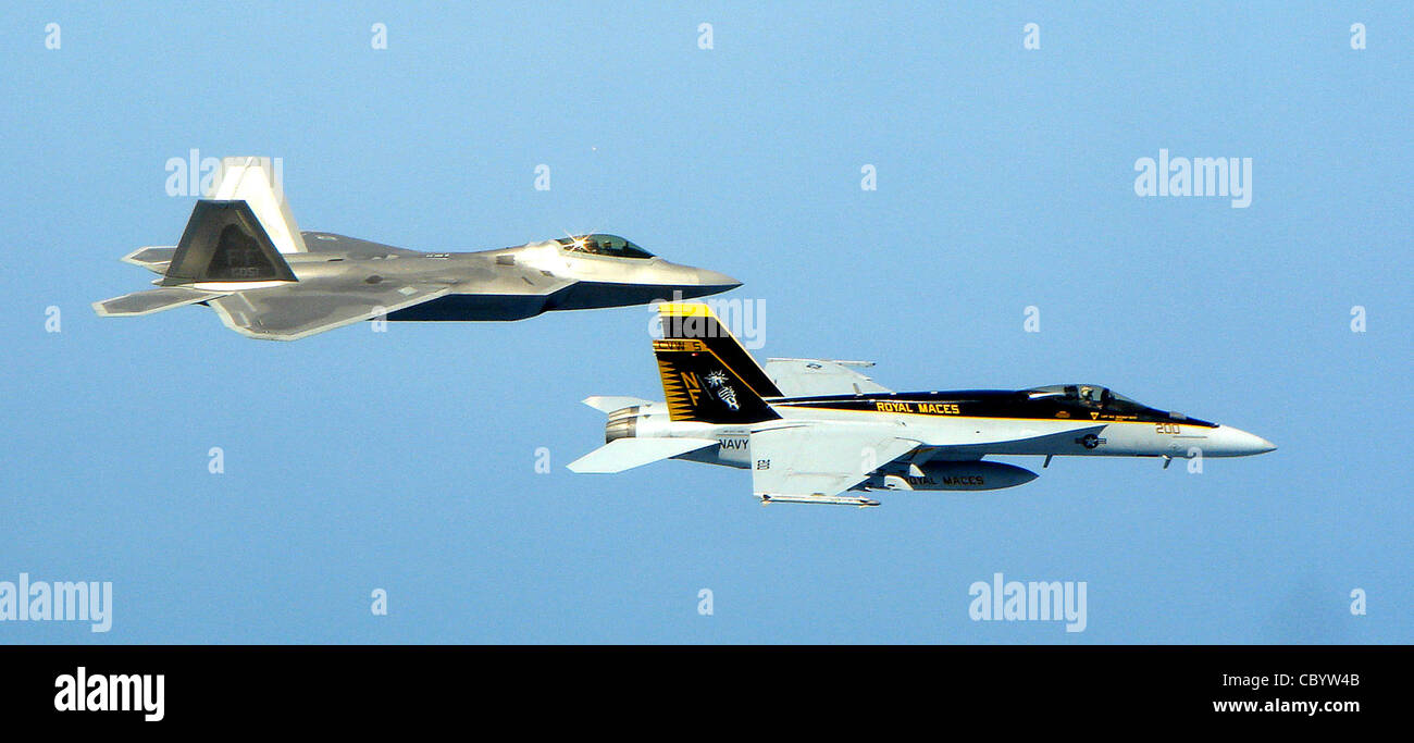 Un F-22A Raptor déployé à la base aérienne de Kadena, au Japon, s'entraîne  avec un F/A-18 Super Hornet de la marine américaine le 26 avril, près  d'Okinawa, au Japon. Les Raptors, du