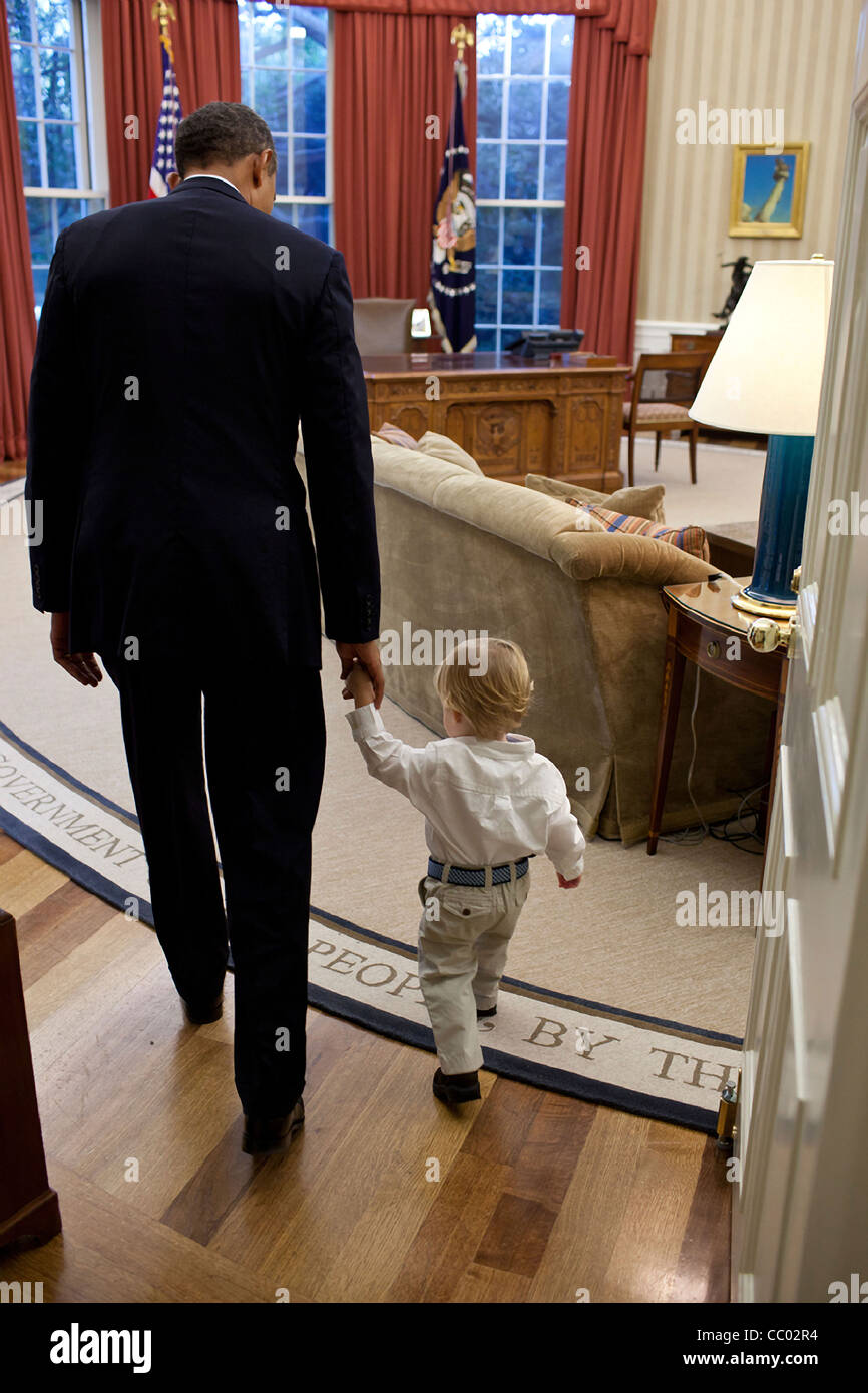 Le président Barack Obama tient la main de William Jones, fils de départ aide Luke Jones dans le bureau ovale le 29 septembre 2011 à Washington, DC. Lorsqu'un membre du personnel quitte la Maison Blanche, le Président invite le membre du personnel et sa famille à l'Oval Office pour une photo de famille Banque D'Images