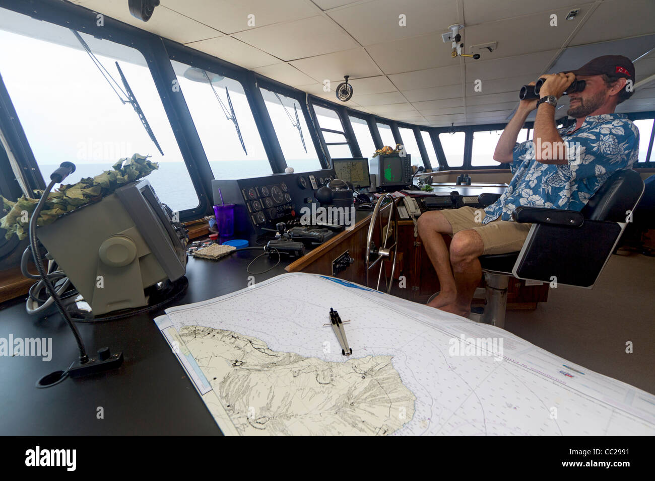 Capitaine à la barre dans la timonerie d'American yacht de croisière Croisières Safari, Safari Explorer, à Hawaii, USA. Banque D'Images