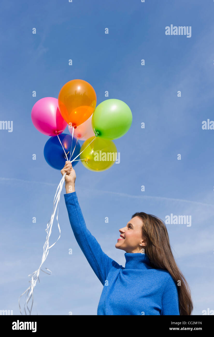 USA, New Jersey, Jersey City, Smiling woman holding balloons Banque D'Images