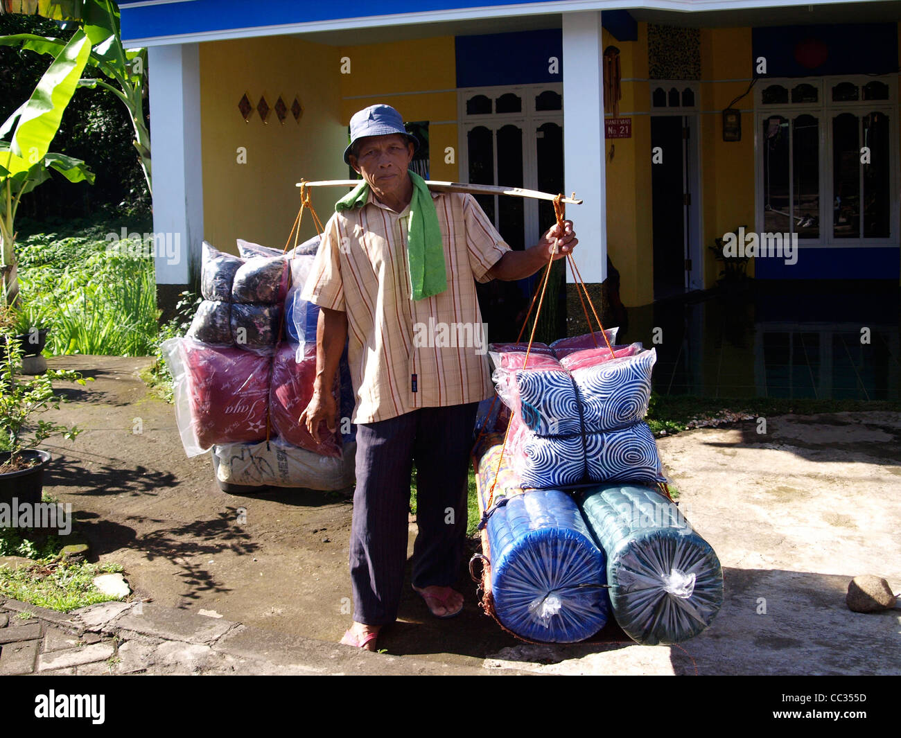 Vendeur de rue, de porte à porte, la vente de literies dans petit village rural java indonésie Banque D'Images