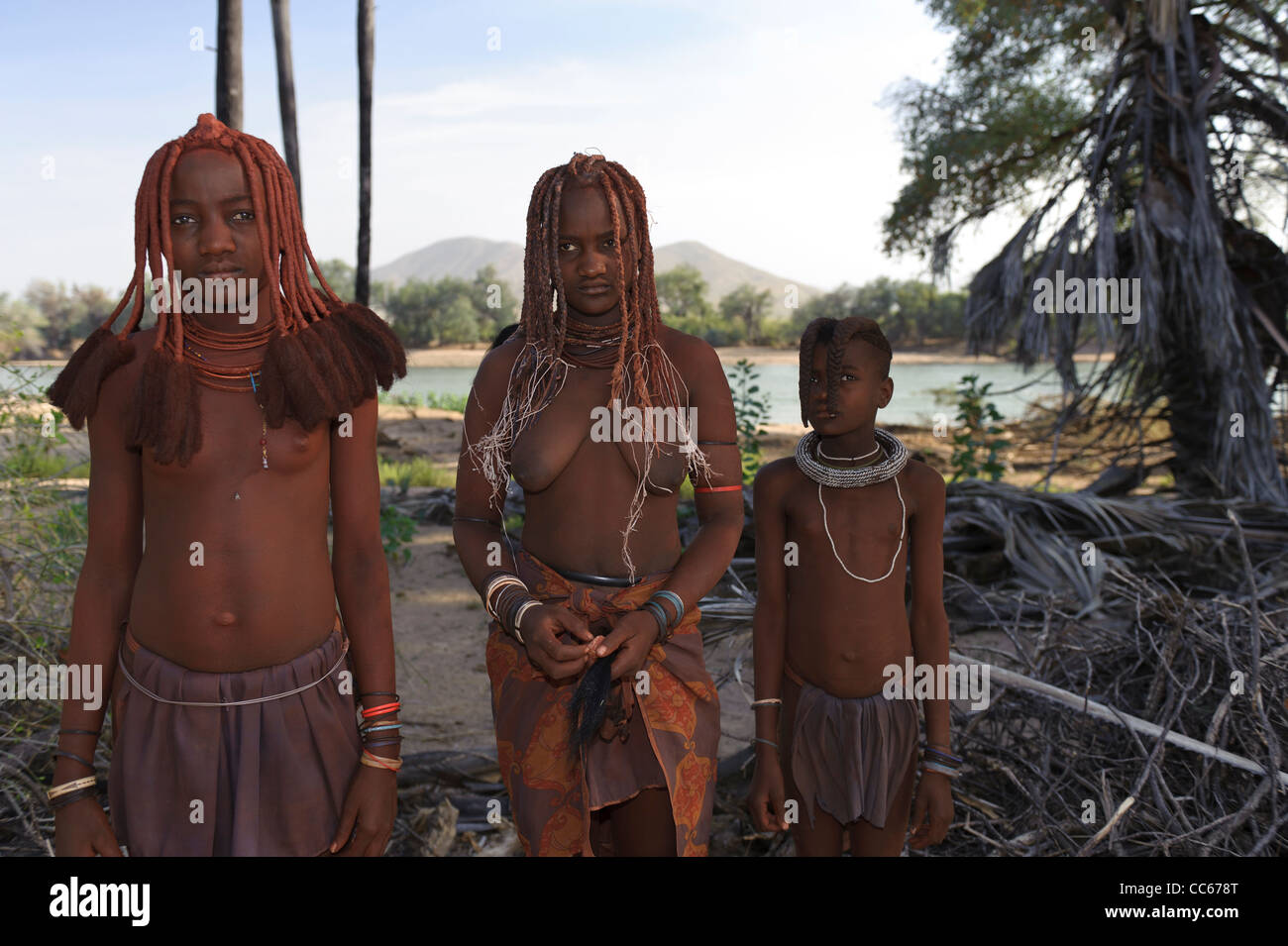 Les filles près de l'Himba Kunene River, la frontière entre l'Angola et la Namibie. Kaokoland, le nord de la Namibie. Banque D'Images