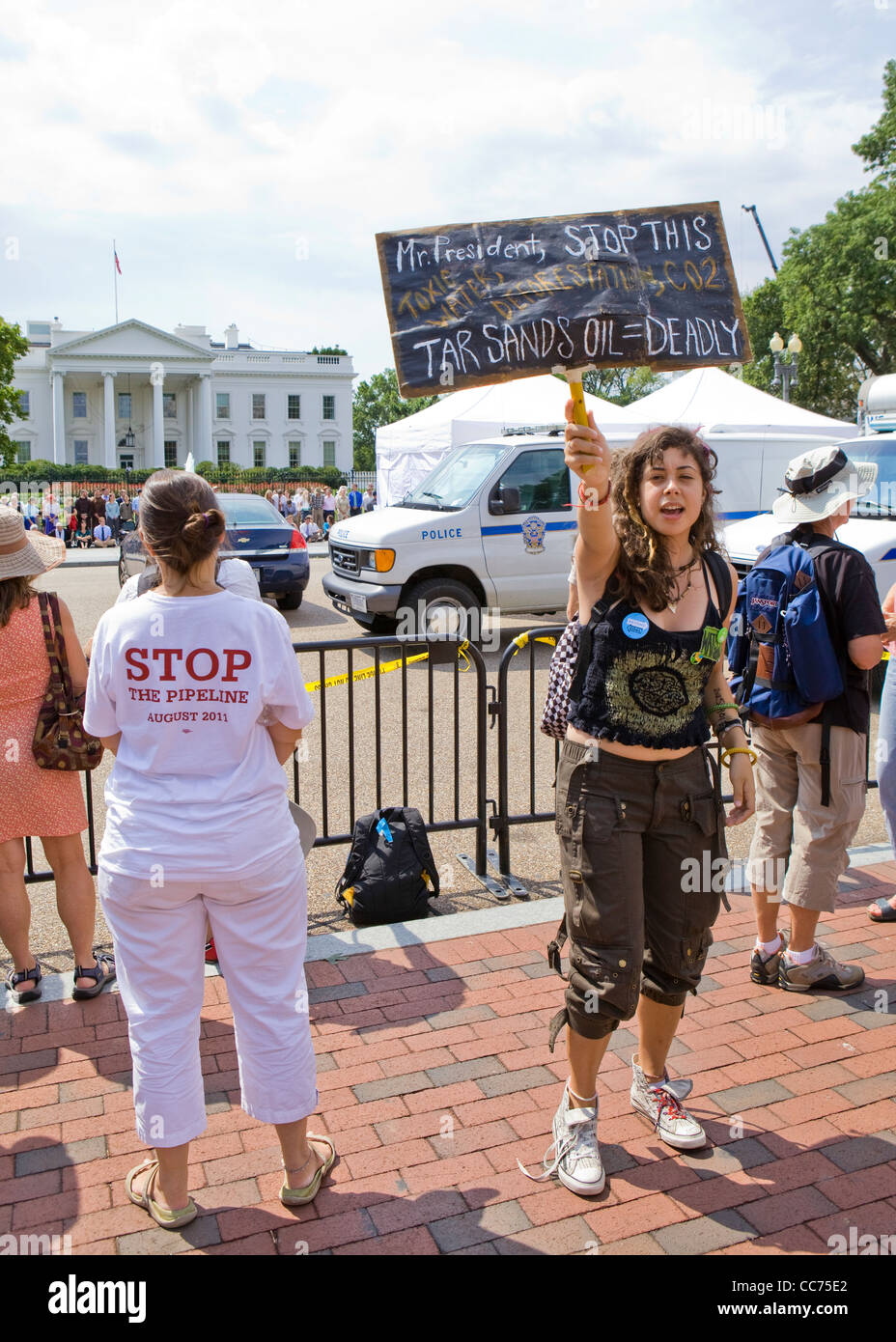 Une femelle manifestant des sables bitumineux holding up un piquet (climat de protestation, manifestant de l'environnement) - USA Banque D'Images
