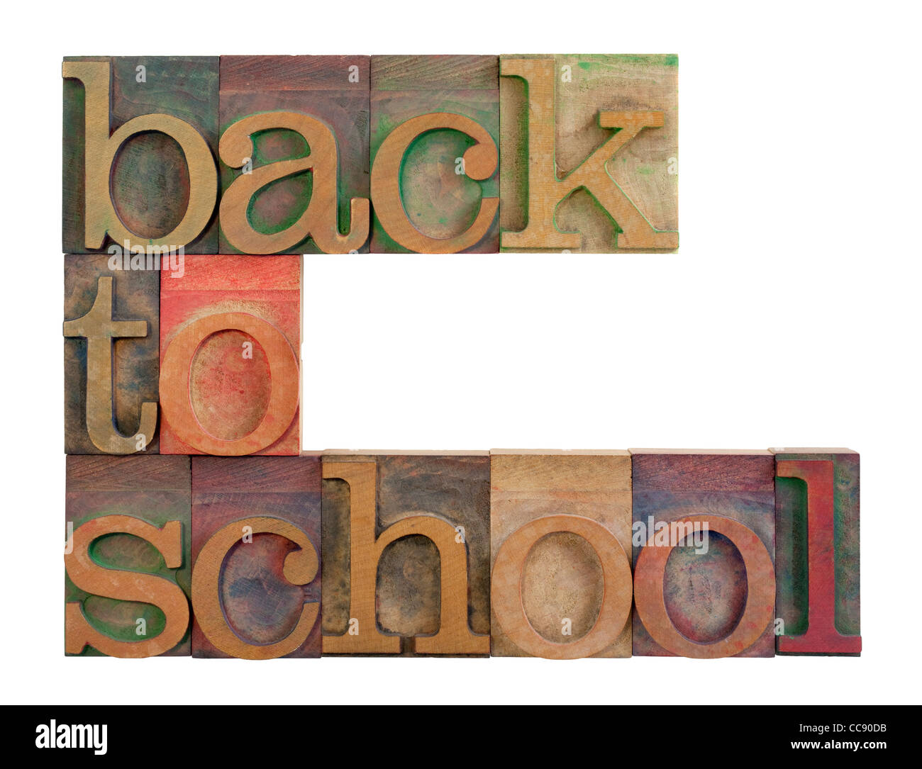 Retour à l'école titre dans la typographie en bois blocs de type vintage, tachés par l'encre de couleur, isolated on white Banque D'Images