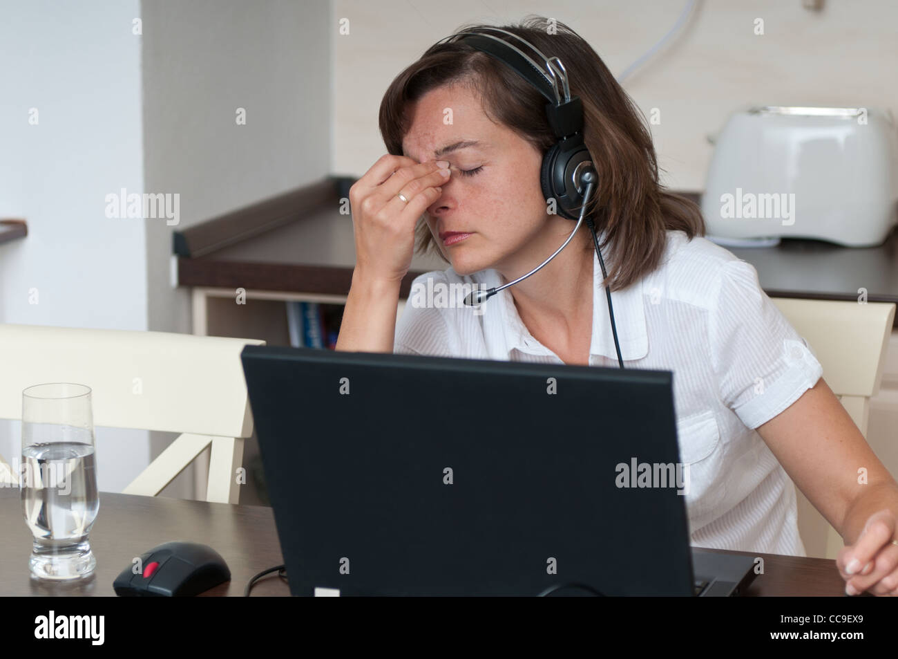 Business Woman avec maux de travailler à domicile Banque D'Images