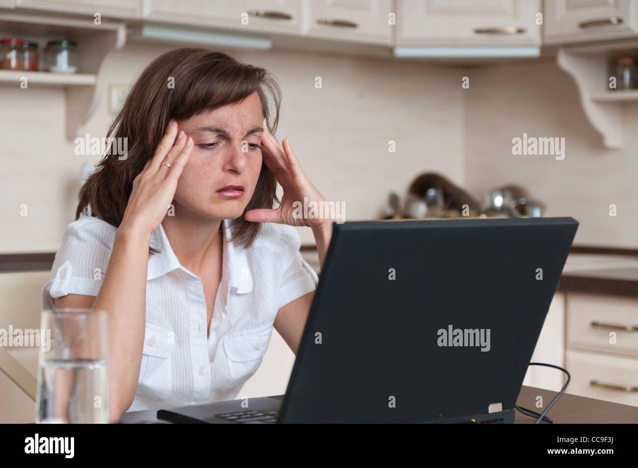 Business Woman avec maux de travailler à domicile Banque D'Images