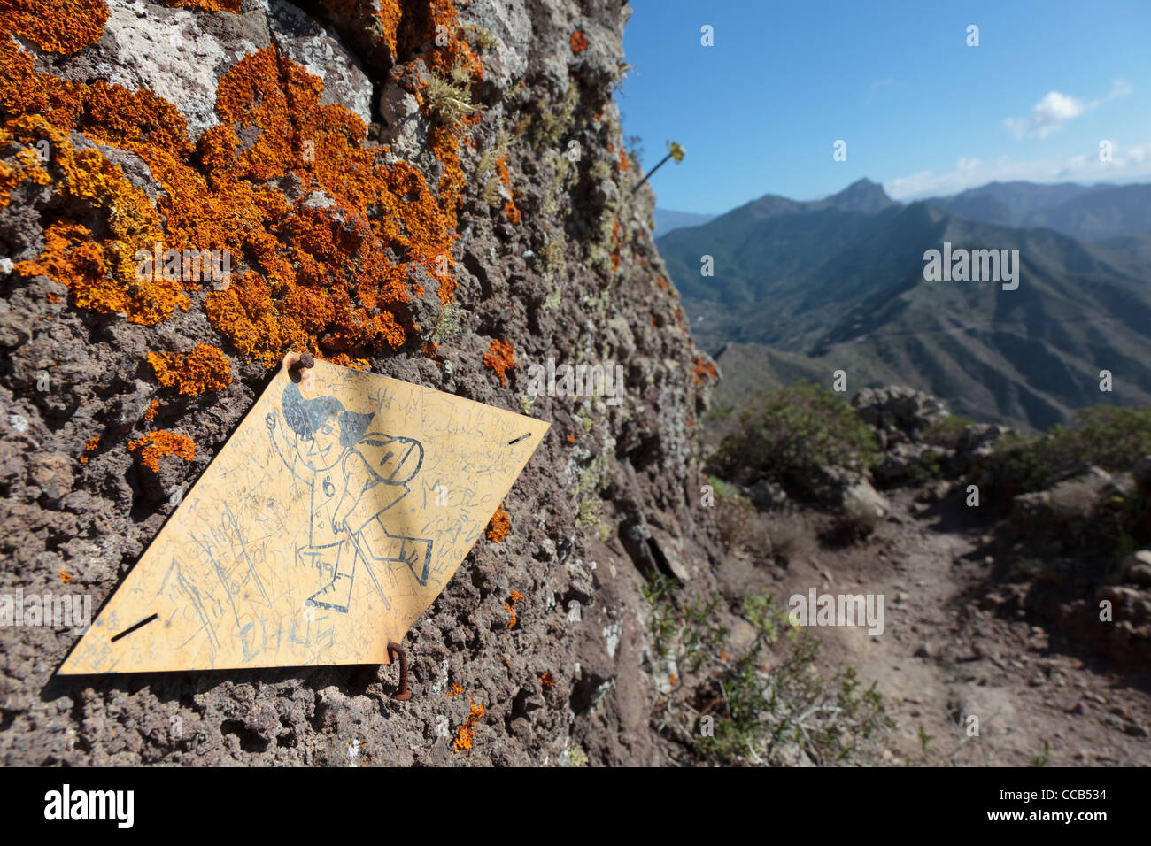 Un marqueur à pied cloué à roches avec lichen orange dans l'affaire Teno Alto Tenerife, Canaries, Espagne Banque D'Images