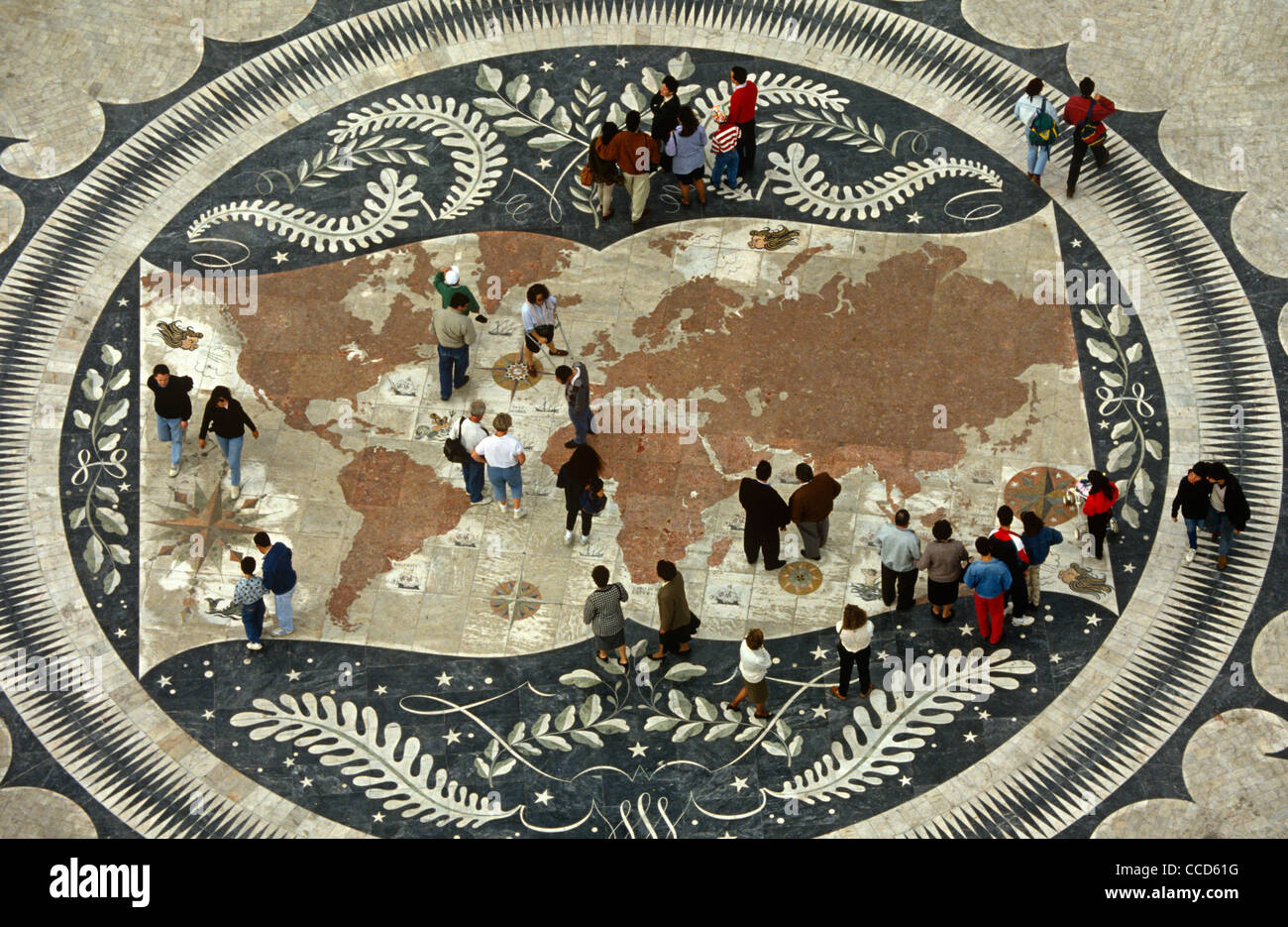 Portugais les piétons marcher sur une carte du monde sur la chaussée sous le Monument des Découvertes, Lisbonne. Banque D'Images