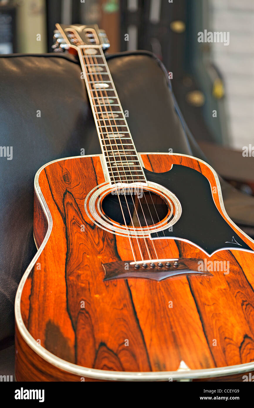 Close-up view of acoustic guitar lying on sofa in music store Banque D'Images