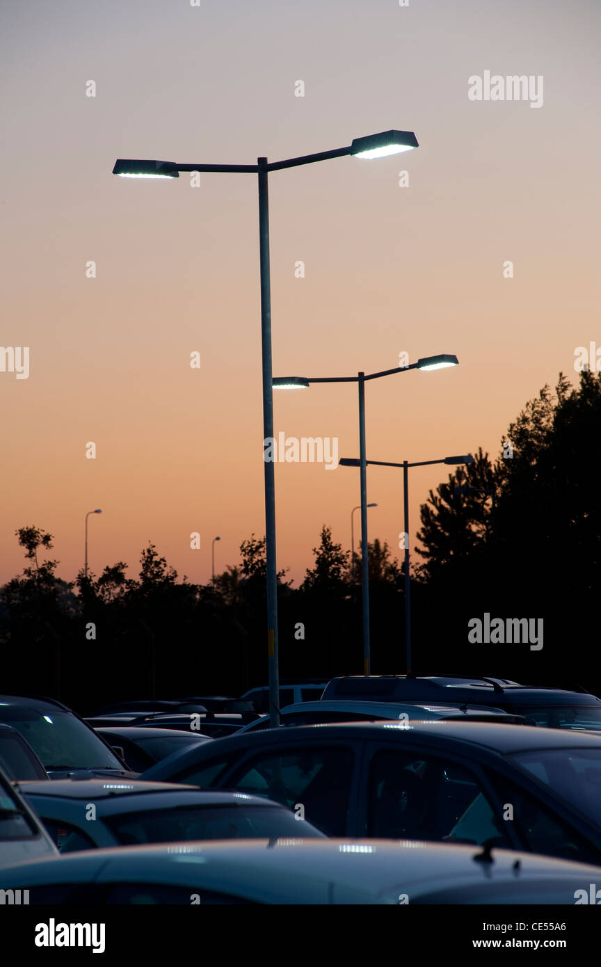 Les véhicules garés dans un parking très occupé au crépuscule en Angleterre. Banque D'Images