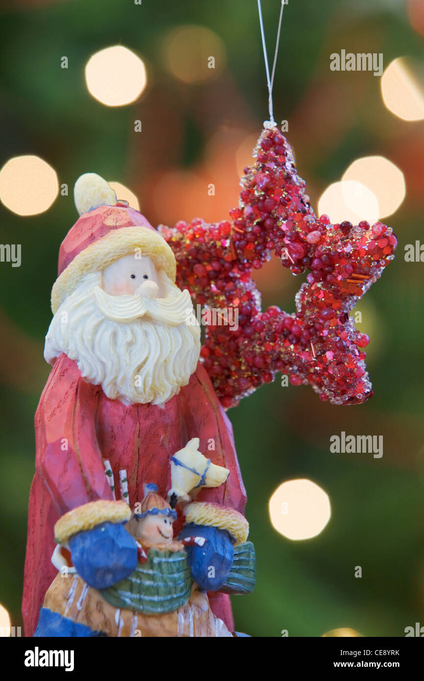 Close up de décorations de Noël en face de lumières sur un arbre de Noël à l'intérieur d'une chambre Banque D'Images