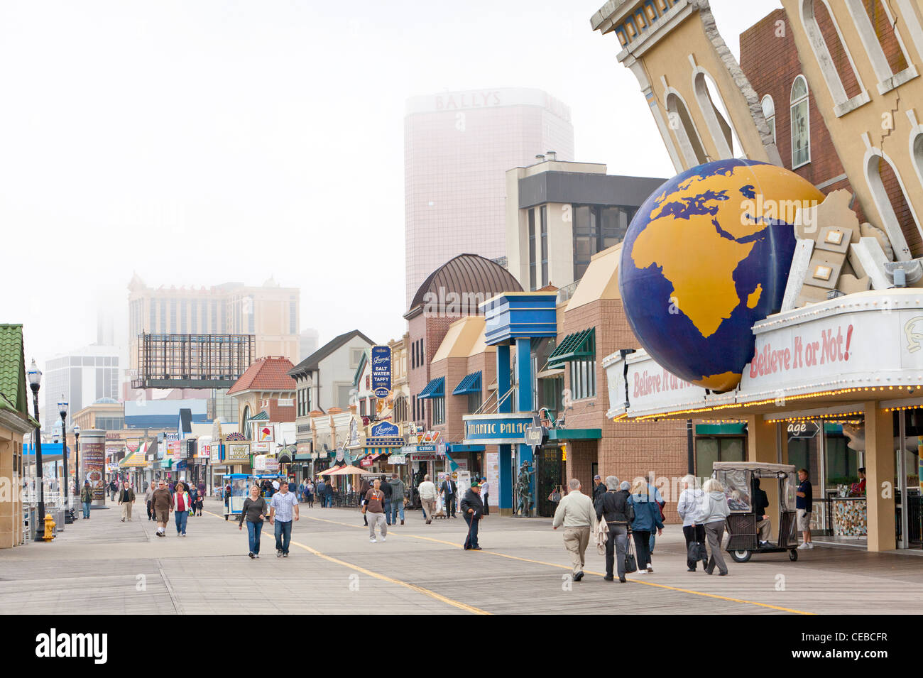 Une journée pluvieuse et foogy sur le Boardwalk à Atlantic City et les touristes et les visiteurs de marcher autour. Banque D'Images