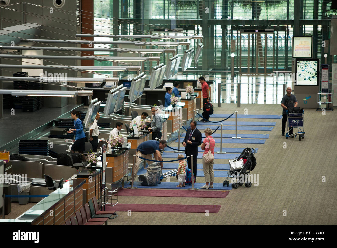 Une famille vérifie à la classe affaires de la compagnie aérienne Singapour 24 au terminal 3 à l'aéroport de Changi à Singapour. Banque D'Images