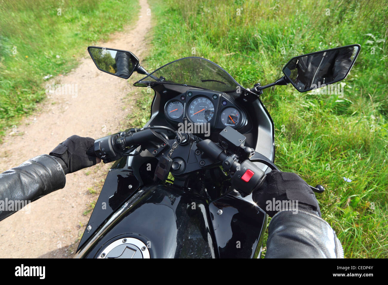 Mains d'un motocycliste on country road, panneau de Banque D'Images