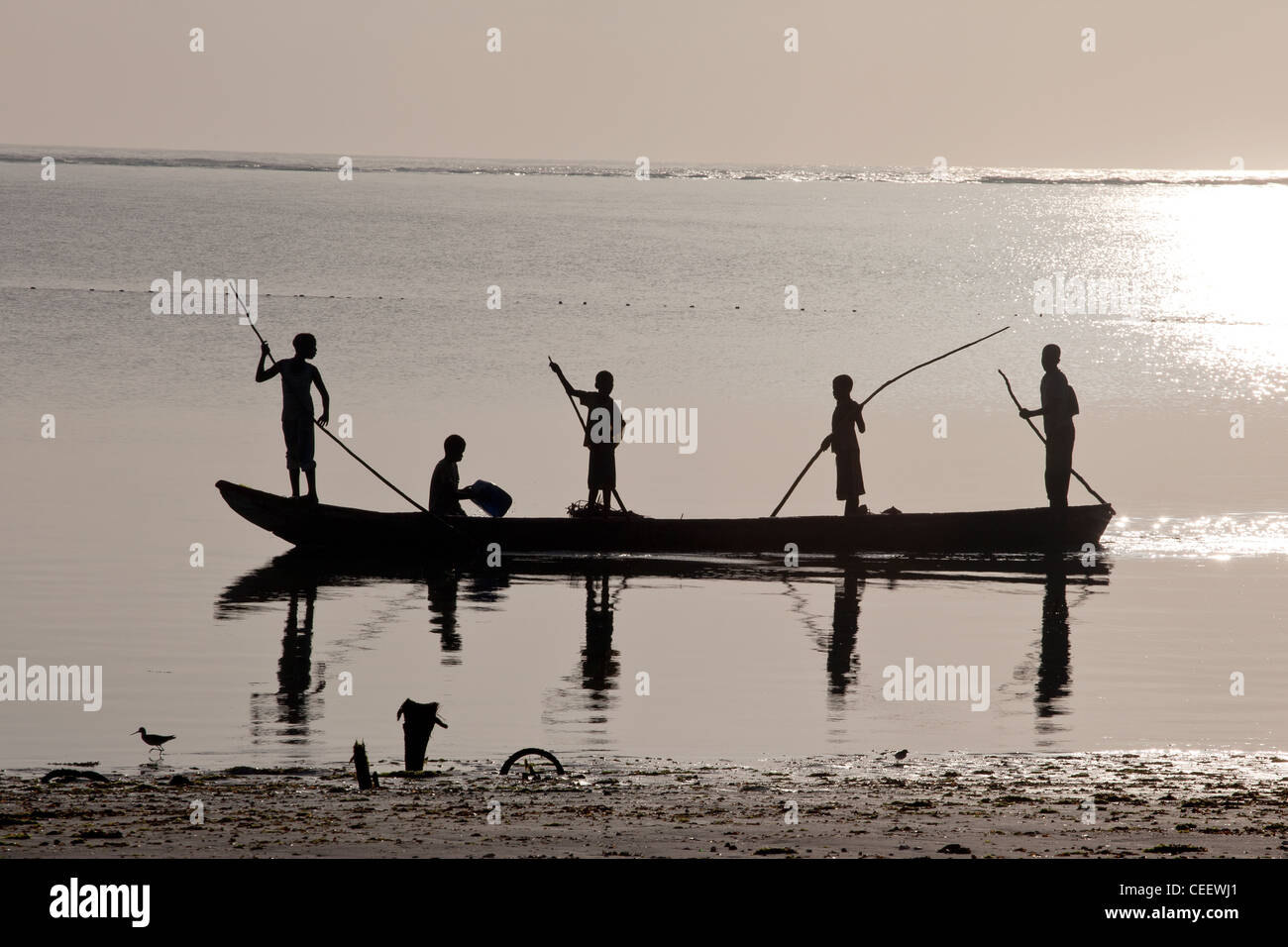 Zanzibari Local Boys Aller à la pêche en barque un dhow dans la mer vers la barrière de corail à Bwejuu, Zanzibar, Tanzanie Banque D'Images