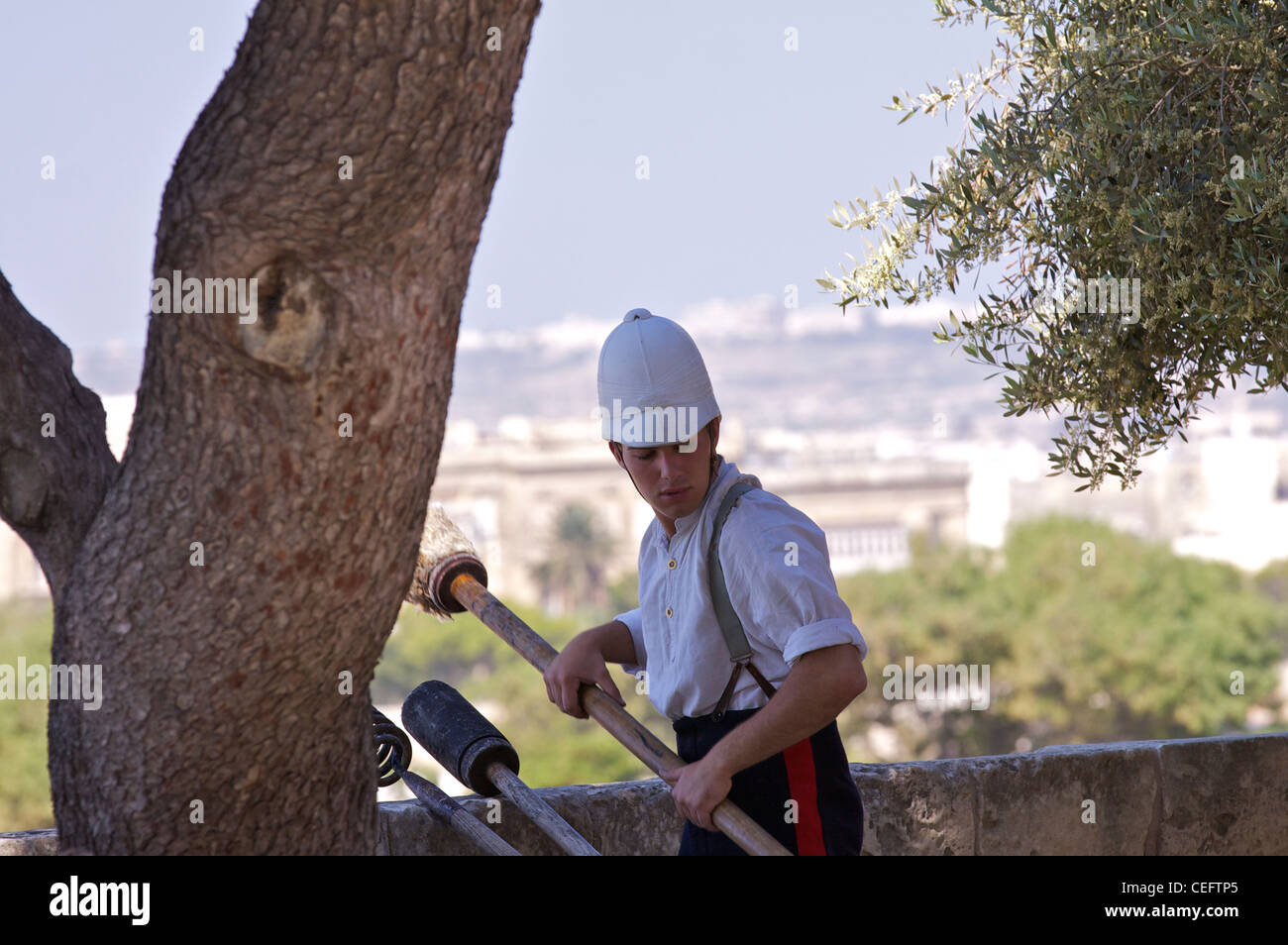 Un soldat prépare le canon restauré dans l'angle supérieur Barracca Gardens pour le tir tous les jours à midi dans la Valette Banque D'Images