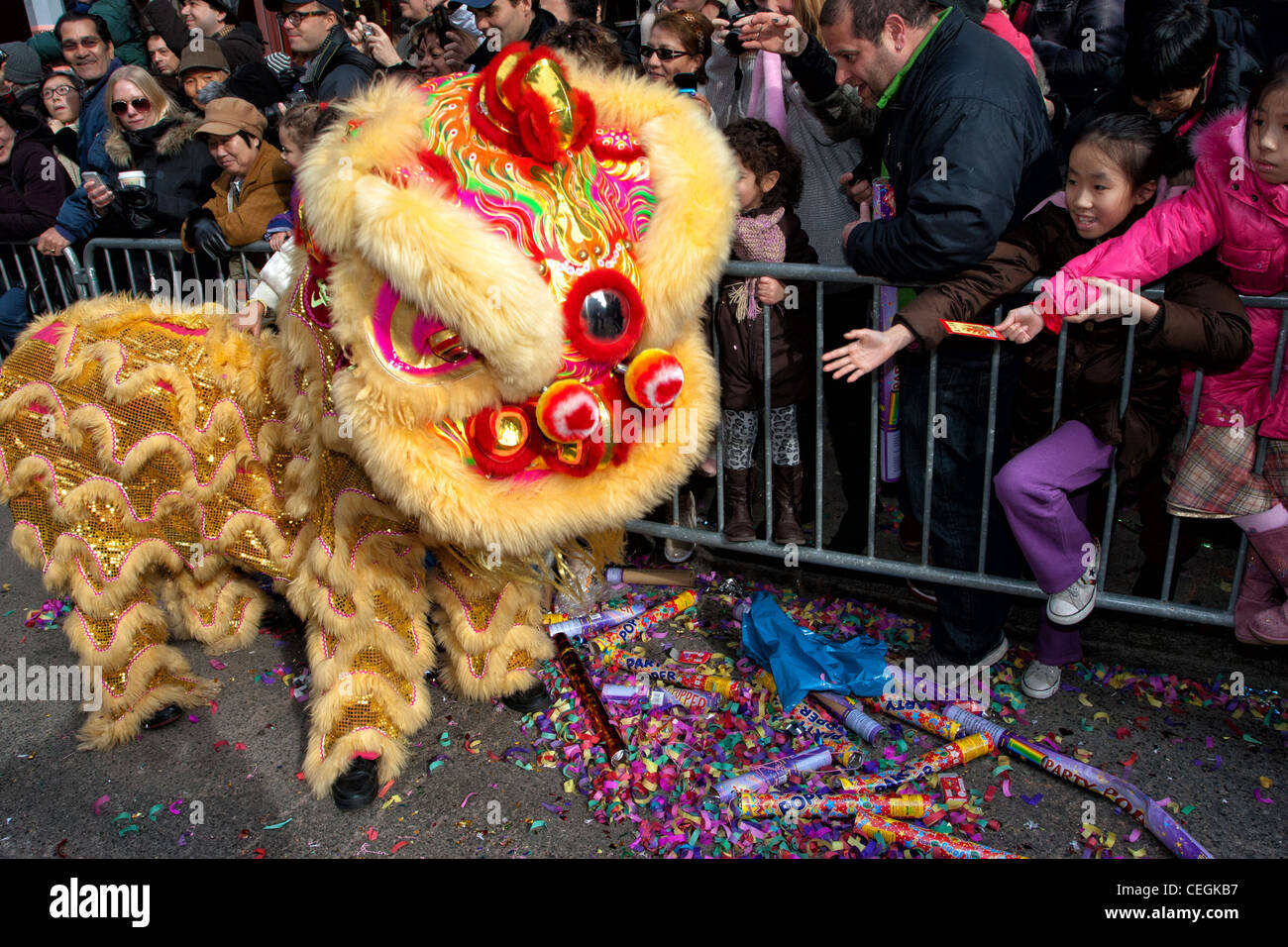 Spectateurs touch un dragon jaune pour la bonne chance à la nouvelle année lunaire 2012 Défilé dans le Chinatown de New York City Banque D'Images