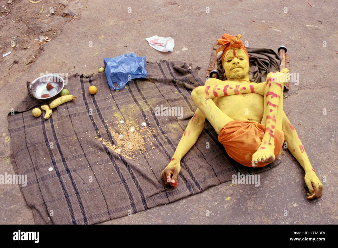 Un mendiant souffrant de la poliomyélite est allongé sur le sol ( Inde) Banque D'Images