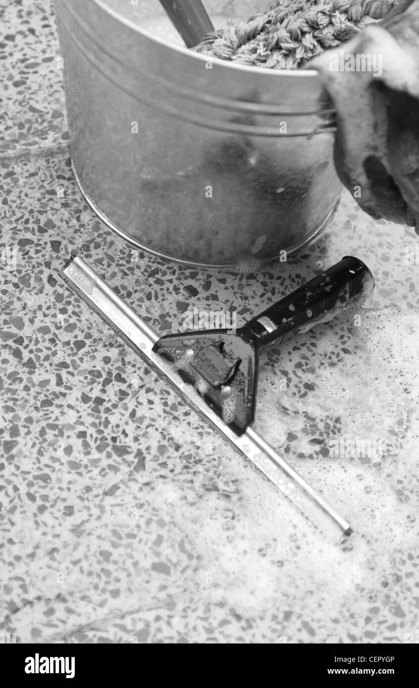 Seau métallique avec de l'eau savonneuse et un chiffon, raclette sur marbre Mike avant Banque D'Images