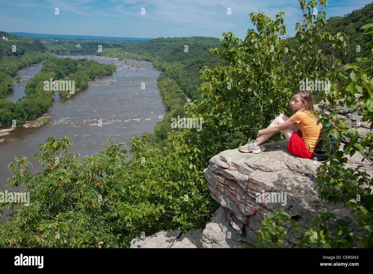 Fille assise sur un rocher surplombant la rivière Potomic, Burkitts, MD Banque D'Images