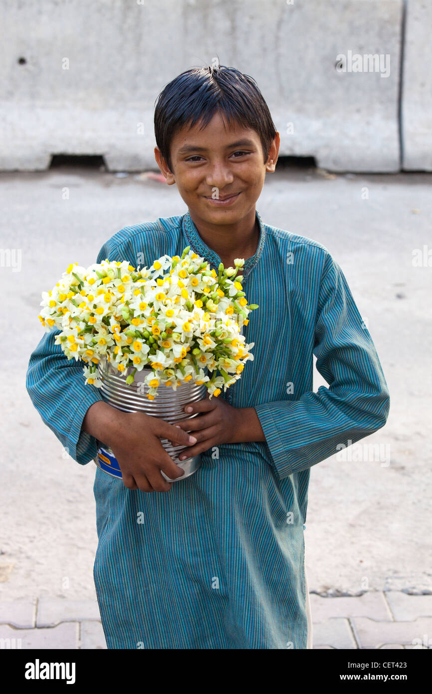 Garçon portant des fleurs à Islamabad, Pakistan Banque D'Images