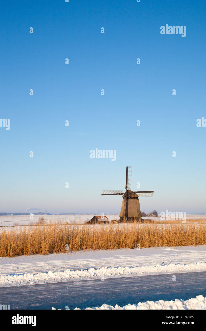 Moulin en hiver avec la neige, la glace et le ciel bleu Banque D'Images