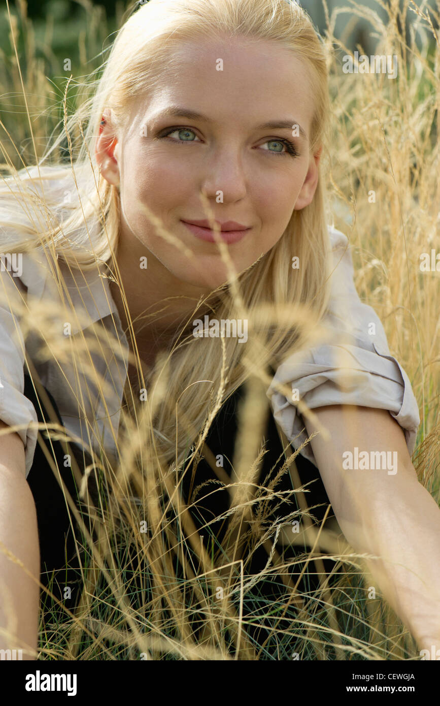 Young Woman Relaxing In Tall Grass Portrait Photo Stock Alamy 