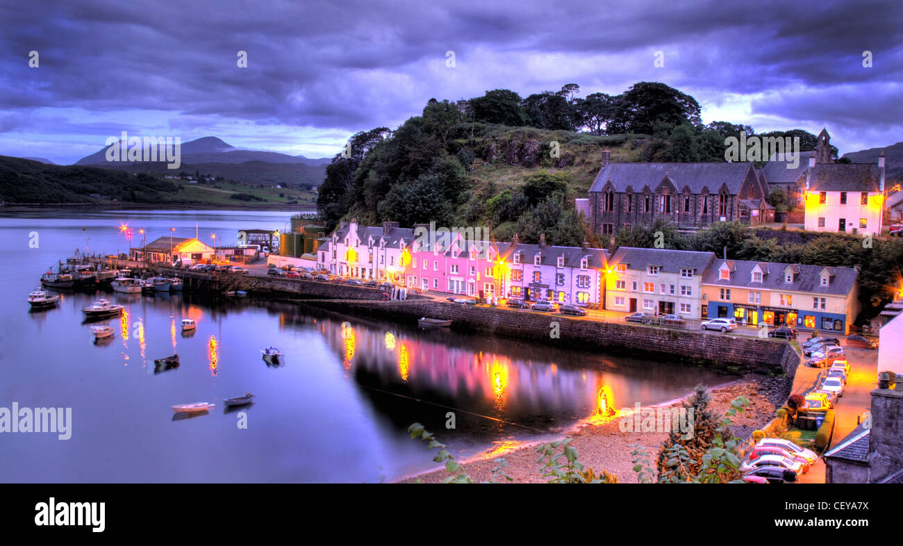 Le port de Portree, Isle of Skye au crépuscule. Les feux de nuit des bateaux et des maisons qui se reflètent dans le magnifique port bateau de pêche Banque D'Images