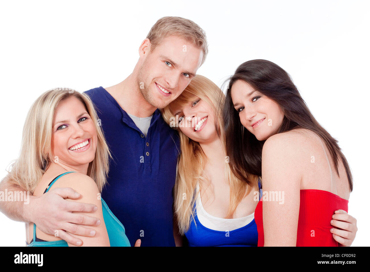 Quatre jeunes amis enlacés, smiling, looking at camera - isolated on white Banque D'Images