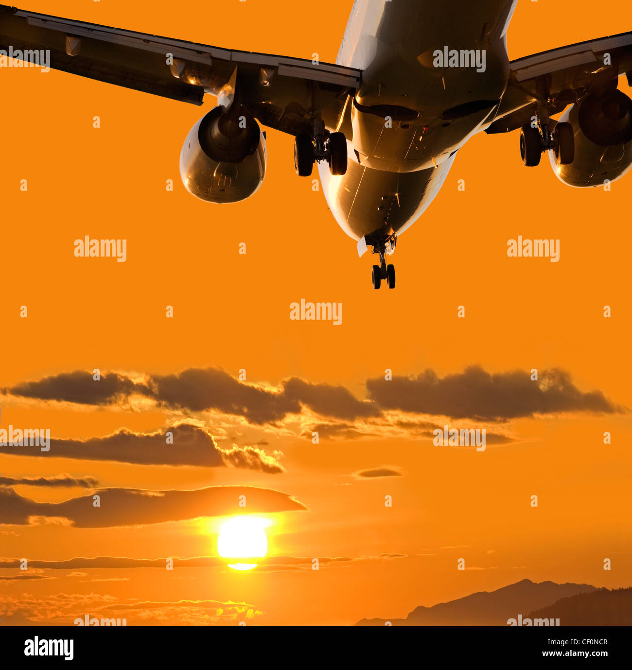 L'atterrissage d'un aéronef dans le coucher du soleil plein Banque D'Images