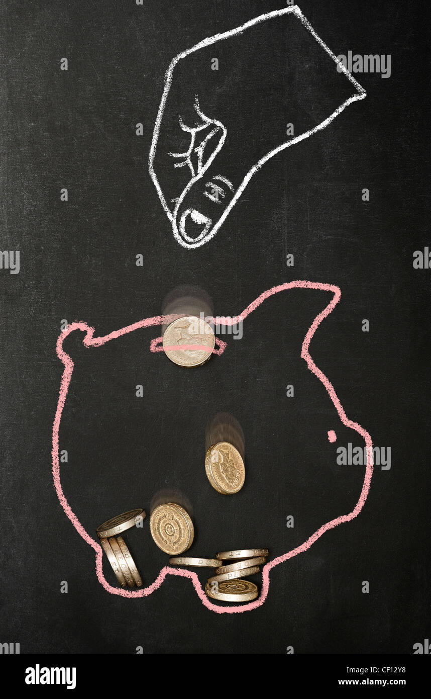 Dessiné à la craie part l'abandon du vrai livre des pièces de monnaie dans une tirelire dessiné à la craie Banque D'Images