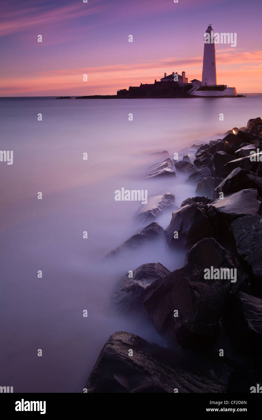 Avant l'aube, le ciel rose au-dessus de St Mary's Island et phare près de Whitley Bay. Banque D'Images