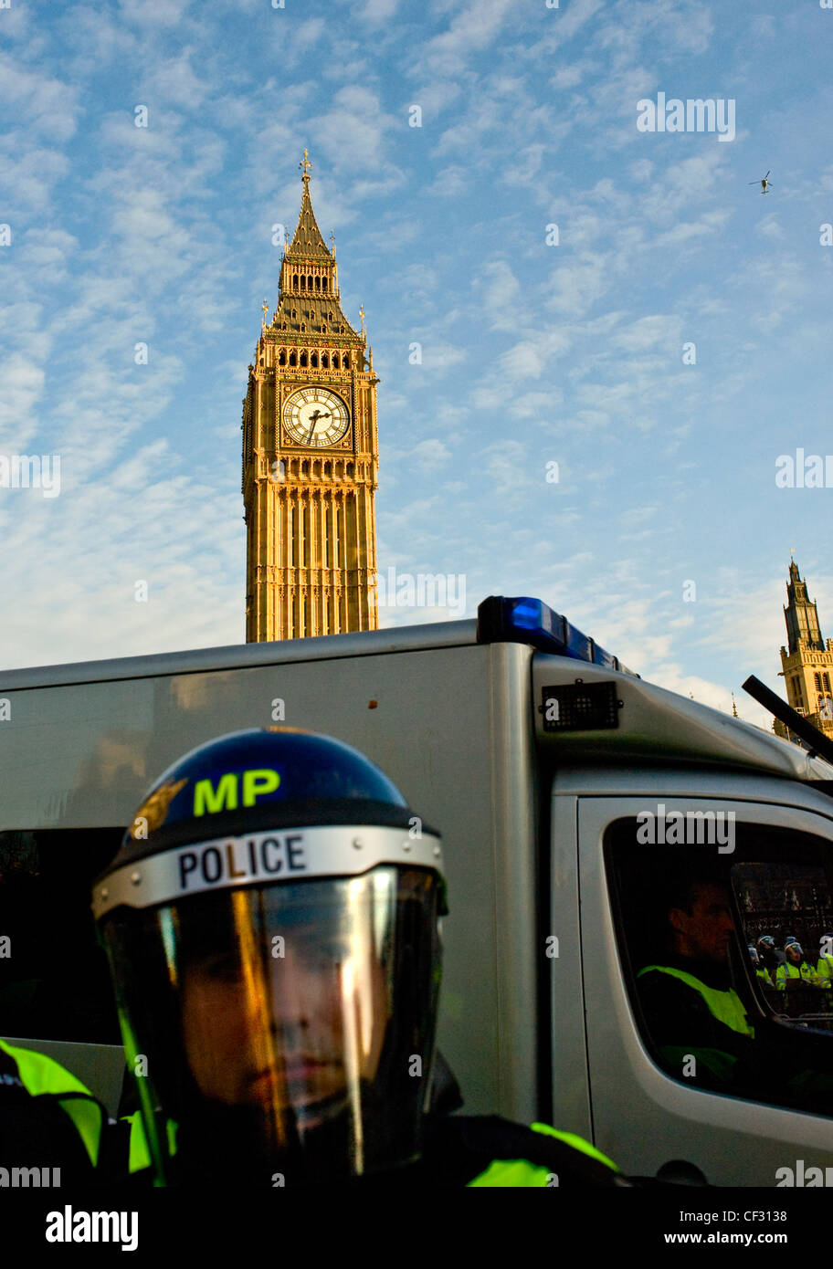 Agent de police anti-émeute métropolitaine la préparation d'une manifestation d'étudiants devant les Maisons du Parlement. Banque D'Images