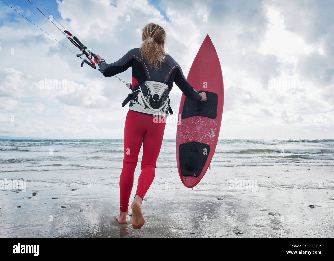 Une jeune femme avec son équipement pour le kite surf sur la plage Dos Mares, Tarifa Cadiz Andalousie Espagne Banque D'Images