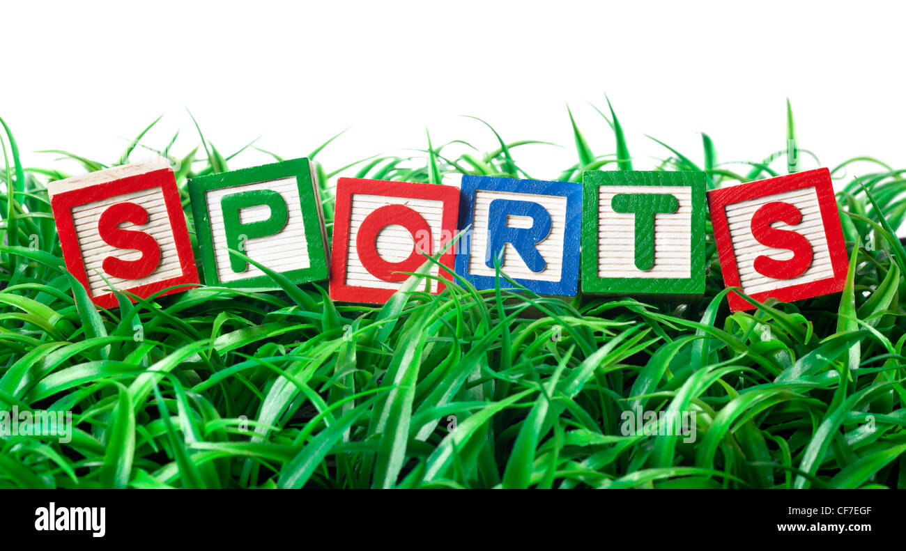 Alphabet blocks former SPORTS sur un patch d'herbe Banque D'Images