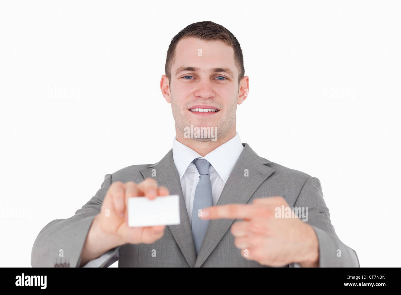 Young businessman pointing at a blank business card Banque D'Images