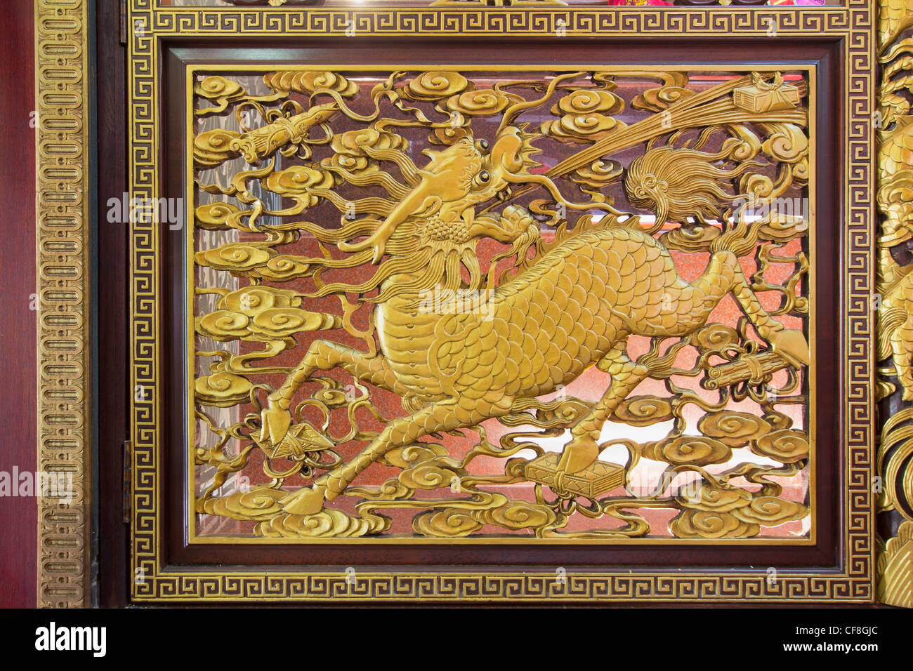 La sculpture sur bois doré or de Qilin chinois sur mur du Temple dans le quartier chinois Banque D'Images